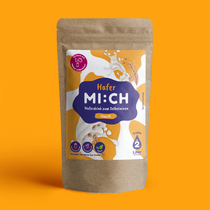 Drinkmich Hafermilchpulver Klassik Haferdrink zum Selbermixen Produktbild Verpackung vor orangenem Hintergrund